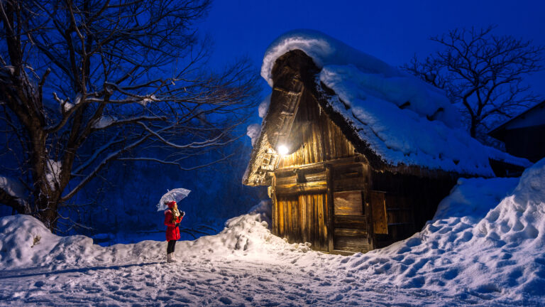Young Woman In Shirakawa Go Village In Winter, Unesco World Heri