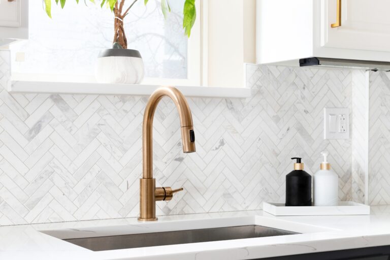 Sink,detail,shot,in,a,luxury,kitchen,with,herringbone,backsplash