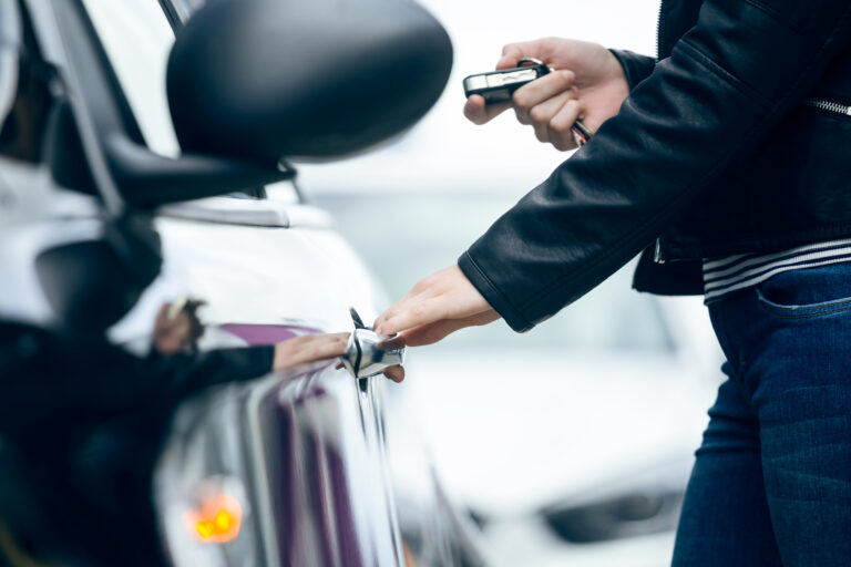 Beautiful Young Woman Opening Her Car.