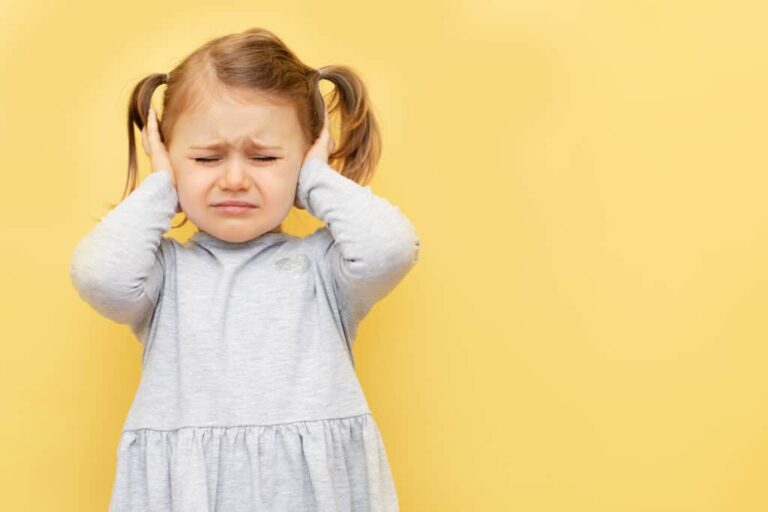 Unhappy Little Girl Kid Close Eyes And Ears Being Annoyed With Noise Wanting Silence And Calm Atmosphere, Isolated Over Yellow Studio Background